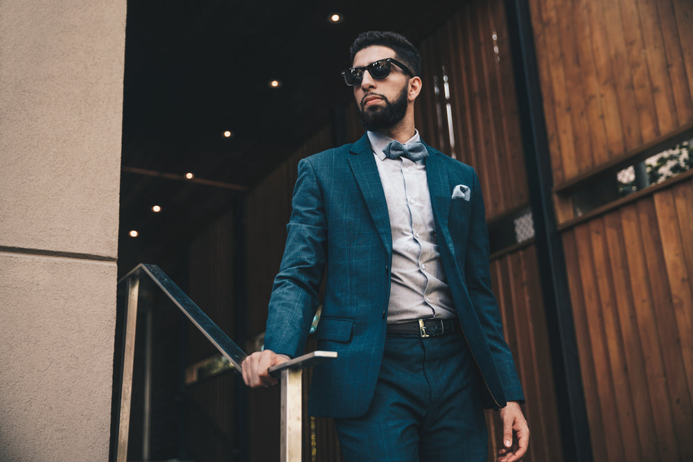 Man in a navy suit with bow tie