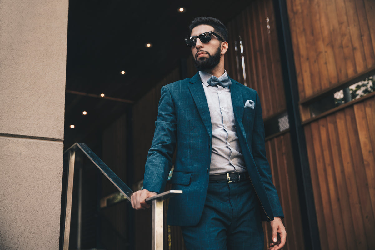 Man wearing a navy suit and bow tie